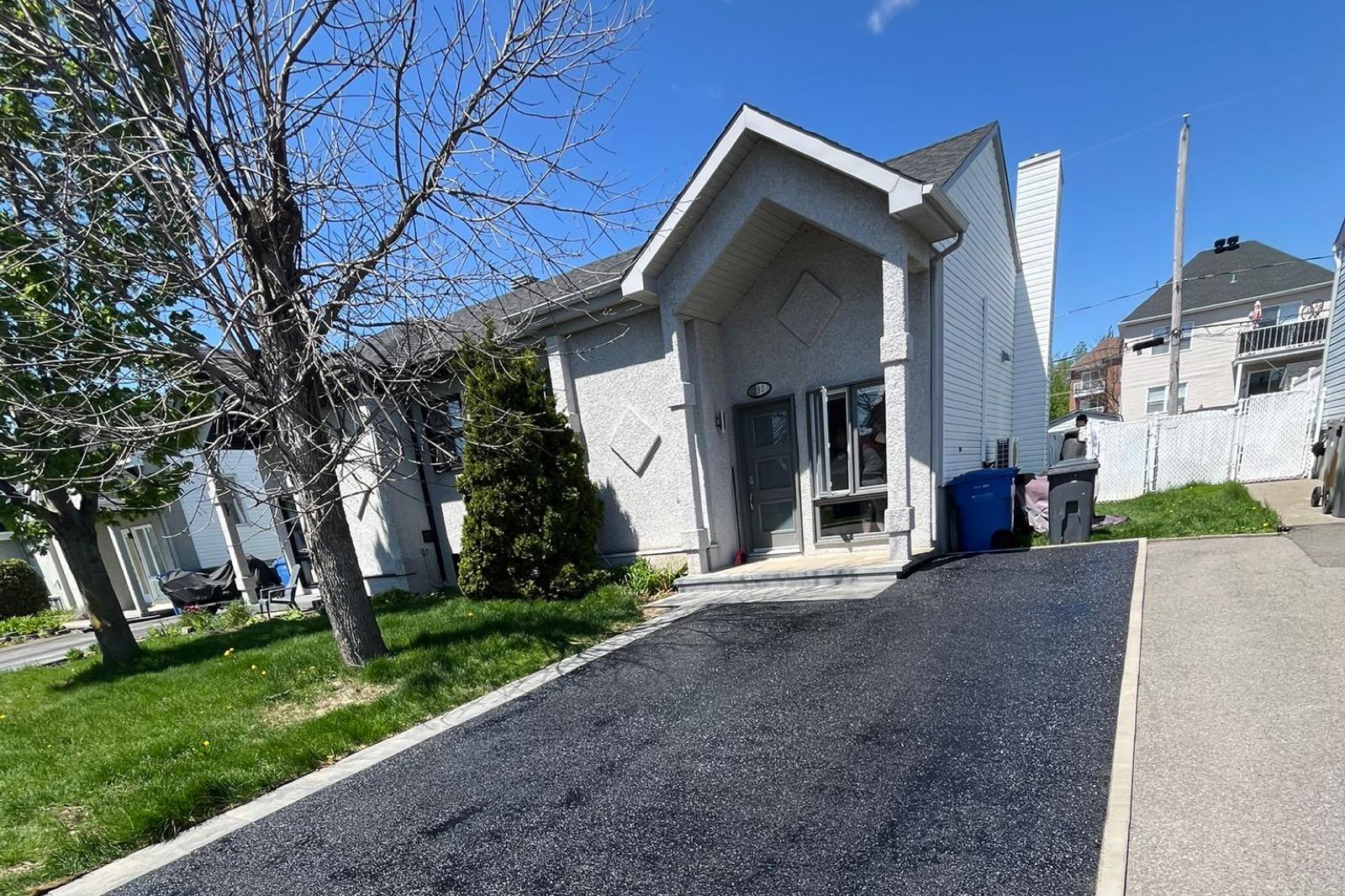 Freshly sealed driveway — uniform black finish — After